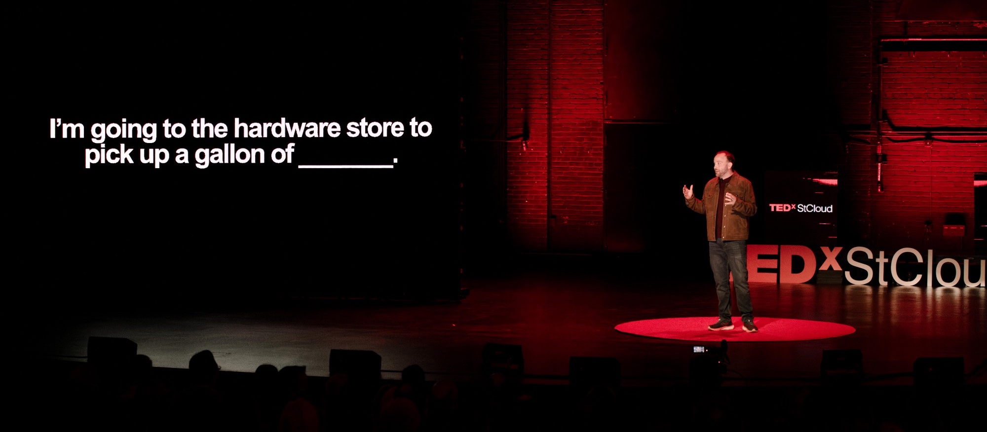 Tim on stage delivering a TEDx talk in October 2023